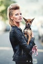 Hes my rock n roll sidekick. Cropped portrait of an edgy young woman holding her small dog outdoors.