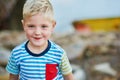 Hes a natural cutie. Portrait of a happy little boy posing outside on his own. Royalty Free Stock Photo