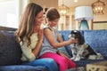 Hes not a pet, hes family. an adorable little girl, her mother and their dog spending time together at home. Royalty Free Stock Photo