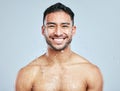 Hes one cool guy. Studio portrait of a handsome young man taking a shower against a grey background. Royalty Free Stock Photo