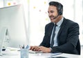 Hes the one on standby today. a mature businessman using a headset while working on a computer in an office. Royalty Free Stock Photo