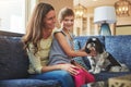 Hes our new dog and hes my best friend. an adorable little girl, her mother and their dog spending time together at home Royalty Free Stock Photo