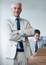 Hes the picture of success. Portrait of an older businessman with his arms crossed in a board room.