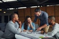 Hes a problem-solver. a group of designers using a digital tablet in their meeting.