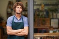 Hes a proud shop owner. A handsome young store owner standing in the entrance of his shop. Royalty Free Stock Photo