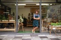 Hes a proud shop owner. A handsome young store owner standing in the entrance of his shop. Royalty Free Stock Photo