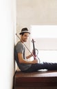 Hes ready to play anywhere, anytime. Handsome young musician holding his violin on a stairwell. Royalty Free Stock Photo