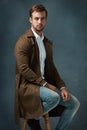 Hes a real trendsetter. Studio portrait of a handsome young man posing against a dark background. Royalty Free Stock Photo