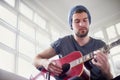 Hes a self-taught muso. a handsome young man playing a guitar at home. Royalty Free Stock Photo