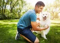 Hes such a good boy. a handsome young man walking his dog in the park. Royalty Free Stock Photo