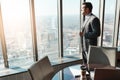 Hes a true business mogul. a young businessman looking out the window in an office. Royalty Free Stock Photo