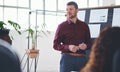 Hes a true leader to his team. a businessman giving a presentation to his colleagues in an office. Royalty Free Stock Photo