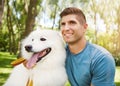 Hes a true and loyal friend. a handsome young man walking his dog in the park. Royalty Free Stock Photo