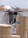 Blast barriers around a damaged trailer on a military camp in Iraq Royalty Free Stock Photo