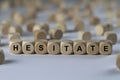 Hesitate - cube with letters, sign with wooden cubes