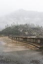 Fogs Among Trees, Dam, and Mountains on a Rainy Day in Hetch Hetchy Reservoir Area in Yosemite National Park, California Royalty Free Stock Photo