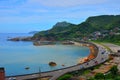 The C-shaped Highway Surrounded the Heterochromatic Ocean and Passed inte Mountains Royalty Free Stock Photo