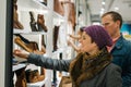 Heterosexual caucasian couple shoe shopping in a boutique shop