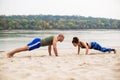 Heterosexual couple work out on the beach