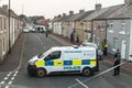 Police with vans close of a street with terraced houses to deal with an incident.  Residential setting Royalty Free Stock Photo