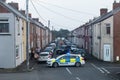 Police with vans close of a street with terraced houses to deal with an incident.  Residential setting Royalty Free Stock Photo