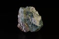 HEULANDITE stone is a green mineral on a dark background