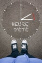 Heure d`ete, FrenchDaylight Saving Time on asphalt with two shoe