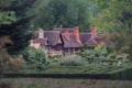 Hever Castle Tudor house buildings in the grounds behind the maze. Shot Telephoto lens on a sunny day summer 2020 Royalty Free Stock Photo