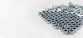 Hex nuts aligned in structured pattern with bolts representing industrial fastening concept Royalty Free Stock Photo