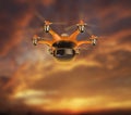 Hexacopter carrying cargo flying in the sunset sky
