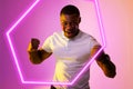 Hexagon neon over african american fan cheering with france flag on cheek during soccer match Royalty Free Stock Photo