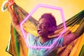 Hexagon neon over cheerful african american fan with flag celebrating victory during soccer match Royalty Free Stock Photo