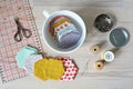 Hexagon patchwork templates, white cup, thread, retro scissors, metal pins and quilting ruler