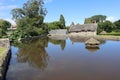 The hexagonal duck house on the village pond at East Quantoxhead in Somerset, England. Thatched cottages can be seen in the