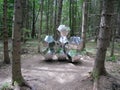 Hexagonal glass sculpture in the middle of forest