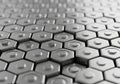 Hexagonal gray metal tiles form an intricate, repeating pattern. Royalty Free Stock Photo
