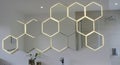 Hexagonal mirrors with backlighting form a honeycomb pattern on a bathroom wall. Royalty Free Stock Photo