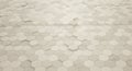 Hexagonal tiles in a beige and light gray color scheme cover a large surface, creating Royalty Free Stock Photo