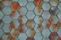 Hexagonal tiles in teal blue with rust-like orange marks, repeated pattern of six-sided polygons in shades of blue-green Royalty Free Stock Photo