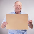 Hey everybody, look what I have. Studio shot of a senior man holding a blank sign against a grey background. Royalty Free Stock Photo