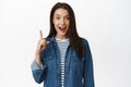 Hey got excellent idea. Excited young woman has suggestion, pointing finger up, smiling and telling big news Royalty Free Stock Photo