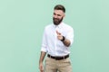 Hey I choose you. Attractive flirting businessman pointing finger and winking at camera choosing you Royalty Free Stock Photo