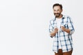 Hey man what is up. Portrait of joyful and friendly happy nice guy with beard and moustache, pointing at camera with