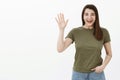 Hey so nice to meet you. Portrait of friendly and excited sincere outgoing woman in t-shirt saying hey as waiving at