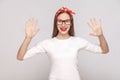 hey, nice to see you. portrait of beautiful emotional young woman in white t-shirt with freckles, black glasses, red lips and Royalty Free Stock Photo