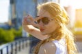 Hey smile you. Portrait of cheeky and cute glamour blond woman in glasses luminescent hair winking happily showing peace victory