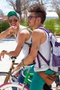 Hey, whatsup. two young guys sitting on their bikes outdoors.