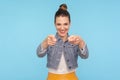 Hey, you are awesome! Portrait of joyful happy fashionably dressed woman with hair bun pointing fingers to camera