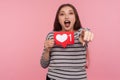 Hey you, click Like and follow my blog! Portrait of blogger woman in striped sweatshirt holding social media Heart button