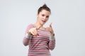 Sassy woman pointing with finger at camera blaming you in all troubles. Royalty Free Stock Photo
